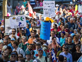 People take part in a protest against the Charter of Quebec Values proposed by the Parti Québécois government in Montreal on Sunday, September 29, 2013.