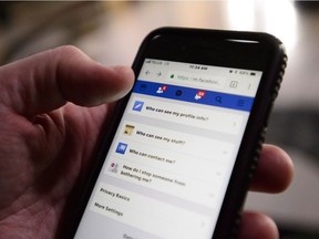 A cell phone user thumbs through the privacy settings on a Facebook account in Ottawa on Wednesday, March 21, 2018. Many Canadians are pledging to delete their Facebook accounts as part of an online campaign encouraging people to permanently log off the site amid mounting concerns that the social media giant is inappropriately sharing users' information beyond their circle of friends.