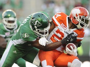B.C. Lions running back Jeremiah Johnson, right, fights for yards as Saskatchewan Roughriders linebacker Henoc Muamba attempts the tackle during first half CFL action in Regina on Sunday, August 13, 2017. The Montreal Alouettes have signed highly sought-after Canadian free-agent linebacker Muamba to a three-year contract.