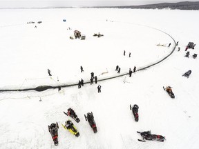 A massive ice carousel on a frozen lake in Sinclair, Maine, is large enough to beat the old record held by a town in Finland; four outboard engines were used to make it rotate.