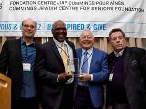 Larry Fredericks Media Award recipient Mitch Melnick presents the big trophy to Montreal Expos Legend Award recipient Tim Raines, helped along by guest of honour Morden (Cookie) Lazarus and Le Journal de Montréal’s Rodger Brulotte at the Cummings Jewish Centre for Seniors Foundation Sports Celebrity Breakfast.