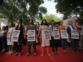 Indian women display placards during a protest against two recently reported rape cases as they gather near the Parliament in New Delhi, India, Sunday, April 15, 2018.