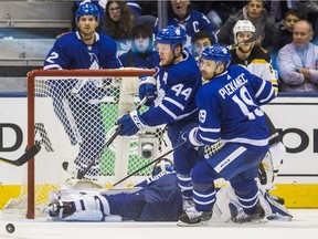 Toronto Maple Leafs' Tomas Plekanec and Morgan Rielly try to clear puck during third period of Game 3 against the Boston Bruins at the Air Canada Centre in Toronto on April 16, 2018.