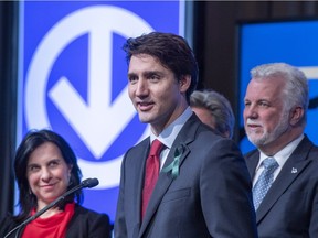 Prime Minister Justin Trudeau, flanked by Montreal Mayor Valérie Plante and Quebec Premier Philippe Couillard, responds to a question during the announcement of the extension of the métro’s Blue Line on Monday, April 9, in Montreal.