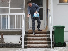 Luc Piriou salts his front stairs and walkway at his Villeray home April 16, 2018.