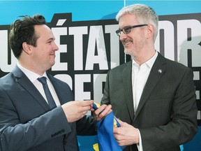 Martin Aussant, right, is congratulated by Maxime Laporte in Montreal, Sunday, April 15, 2018, after being selected as the Parti Quebecois candidate for the riding of Pointe-aux-Trembles ahead of the upcoming provincial election.