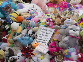 A message rests among plush toys before a silent march to commemorate Rosalie's death on April 24 in Quebec City.