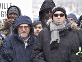Mohamed Yangui, right, president of the Quebec Islamic Cultural centre, walk to the Quebec legislature at a march in solidarity to the victims of the mosque shooting, Sunday, February 5, 2017 in Quebec City.