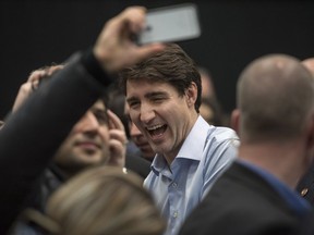 Prime Minister Justin Trudeau poses for a selfie at a Liberal event in North Battleford, Sask. on Thursday, December 7, 2017.