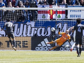 Los Angeles FC forward Carlos Vela (10) scores past Montreal Impact goalkeeper Evan Bush as Los Angeles FC defender Omar Gaber (4) looks on during second half MLS action Saturday, April 21, 2018 in Montreal.