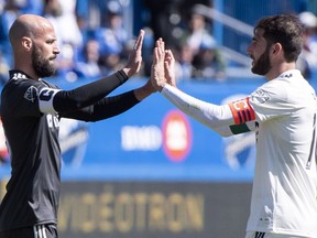 Los Angeles FC defender Laurent Ciman and Montreal Impact midfielder Ignacio Piatti (10) meet at centre field following the Los Angeles' 5-3 victory in MLS action Saturday, April 21, 2018 in Montreal.