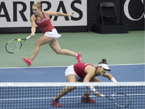 Gabriela Dabrowski, left, and Bianca Andreescu of Canada play a shot to Kateryna Bondarenko and Olga Savchuk of Ukraine during their doubles match at the Fed Cup tennis tournament in Montreal, Sunday, April 22, 2018.