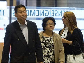 Sy Veng Chun and Leng Ky Leck, a couple accused of money laundering, along with their legal team make their way to a Montreal courtroom Sept. 15, 2014.