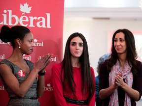 Former Quebec Immigration minister Yolande James, left, and former Liberal candidate Marwah Rizqy, right, applaud as Emmannuella Lambropoulos is announced as the Liberal Party of Canada nominee in the Saint-Laurent riding in Montreal on Wednesday, March 8, 2017.