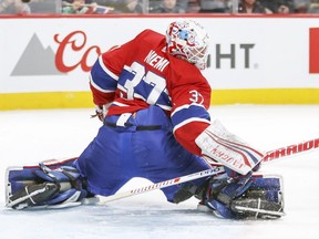 Montreal Canadiens goalie Antti Niemi twists his body to make a save against the Florida Panthers during game in Montreal on March 19, 2018.
