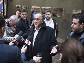 Quebec Islamic Cultural Centre president Boufeldja Benabdallah reacts to the judge's decision to forbid the publication of a surveillance video of the mosque shooting, Wednesday, April 11, 2018 at the courthouse in Quebec City. Ahmed Cheddadi, right, who was injured in the mosque shooting, looks on.