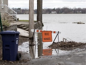 9th Avenue in Laval is closed as the Mille-Îles River begins to spill its banks April 30, 2018.