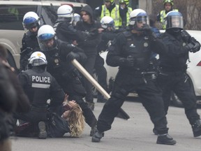 Riot police engage with protesters during a May Day demonstration held by the Convergence des lattes anti-capitalistes in  Montreal.