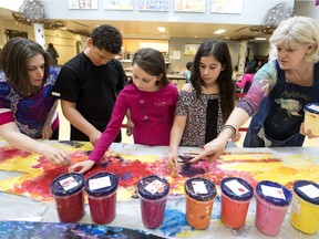 Art teacher Erin Wainwright, left to right, Grade 6 students Brayden Williams, Holly Michon-Cave, Kayla Cordeiro and artist Madeleine Turgeon work on a project at Birchwood Elementary school in St-Lazare.