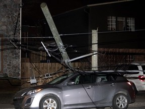 Firefighters secured 6th Ave. in LaSalle after high winds that gusted up to 94 km/h caused falling trees to snap hydroelectric poles  Friday night.
