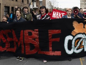 Demonstrators protest in Montreal, Saturday May 5, 2018, outside the condo building from which a Nazi flag had been waved.