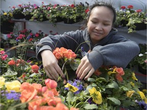 Maria Nguyen prepares flowers for customers looking for Mother's Day gifts at Atwater market on Friday May 11, 2018.