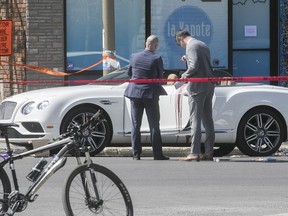 Montreal police officers examine car in which Samy Mokademm was shot in Rosemont on Monday, May 14, 2018.