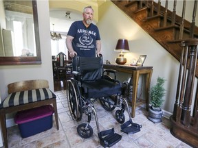 Jon Weinstein rolls his daughter Annie's wheelchair through their home in Beaconsfield on Monday. Annie, 16, suffers from chronic Lyme disease. (John Mahoney / MONTREAL GAZETTE)