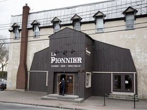 A customer enters the Pioneer resto-bar in Pointe-Claire Village on May 10.