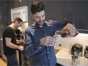 Grégoire Bergeron Chiasson, front, and Etienne Delpech prepare a whiskey sour in the kitchen of Chiasson's condo located in Park Extension. He and friends host regular cocktail nights.