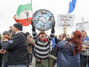 Members of right-wing group Storm Alliance hold a demonstration near the Canada-USA border at Lacolle, south of Montreal Saturday May 19, 2018. (John Mahoney / MONTREAL GAZETTE) ORG XMIT: 60709 - 2466