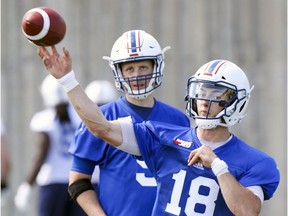 Mattew Shiltz passes the football as fellow quarterback Drew Willy watches during the first day of Alouettes training camp at Olympic Stadium. The two are battling for the starting QB position on the team.