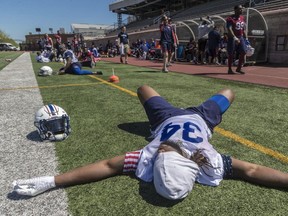 An exhausted Josh Robinson, Montreal Alouettes running back during a break at training camp at Molson Stadium in Montreal, on Monday, May 21, 2018.