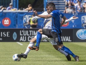 Montreal Impact midfielder Saphir Taider and L.A. Galaxy midfielder Jonathan dos Santos battle for the ball during first-half MLS action at Saputo Stadium in Montreal on Monday, May 21, 2018.