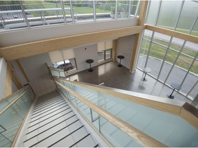 Inside Dollard-des-Ormeaux's newly-expanded Community Centre, the exposed wooden staircase is akin to the trees in the park, and the eight metre-high glass front with mullions criss-crossing two floors represents the random forms found in nature.
