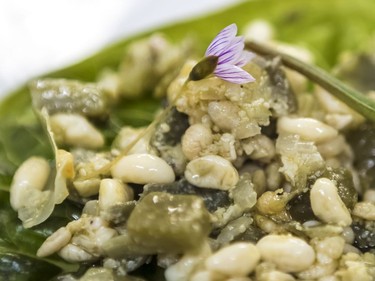 A closeup of escamomles, or ant eggs, also known as Mexican caviar, mixed with onion and Nopal cactus.
