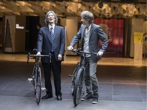 Kent Nagano, left, and actor/comedian Emmanuel Bilodeau arrive by bike for the announcement of the OSM's summer season at Place des Arts on Wednesday, May 23, 2018. Bilodeau will host several outdoor OSM events.
