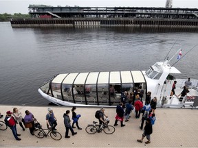 A crowd lines up to board the Old Port to Pointe aux Trembles river ferry in the Old Port Montreal on Monday May 28, 2018.
