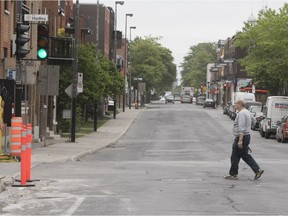 A man crosses De L'église Ave. at Hadley St.in Montreal on Monday May 28, 2018. The mayor of Sud-Ouest presented a new development plan for the western sector of St-Henri and parts of Côte-St-Paul that will include a three-kilometre bike path that will run down de l'Eglise Ave., enlarged sidewalks and safer intersections.