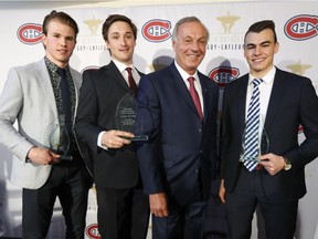 Guy Lafleur stands with recipients of his Awards of Excellence and Merit for 2017-2018, from left, Alexandre Alain of the Blainville-Boisbriand Armada, Carl Neill of the Concordia Stingers and William Lemay of the CEGEP de Saint-Hyacinthe Laurets, in Montreal on Tuesday, May 29, 2018.  The awards are presented annually to hockey players at the amateur level who best combined hockey performance with academic excellence.