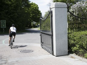 A cyclist makes his way into Mount Royal Cemetery from Camillien-Houde Way May 30, 2018.