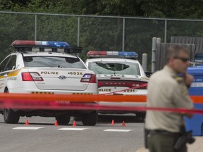 A police car with its back window shot out sits beside Surete du Quebec headquarters, at 599 Harwood Blvd in Vaudreuil-Dorion, west of Montreal Tuesday, July 26, 2016.