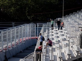Formula E fans sit behind barriers in Montreal on Friday, July 28, 2017. The city will be renting out the barriers for the G7 summit this summer.