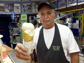 Owner Gilles Prudhomme offers a cone to a customer at Crème Bo-Bec.