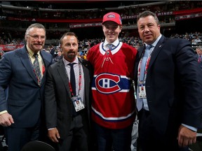 Defenceman Cale Fleury poses for photo with Canadiens management after being selected in the third round (87th overall) at the 2017 NHL Draft in Chicago.