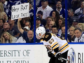 A fan holds up a "Hey Rat lick this" sign at Bruins' Brad Marchand