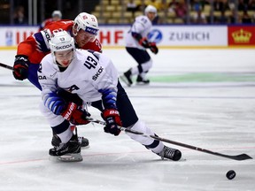 Martin Roymark of Norway and Quinn Hughes, 43, of United States battle for the puck during the World Hockey Championship on May 13, 2018, in Herning, Denmark.