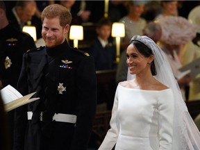 Prince Harry looks at his bride, Meghan Markle, as she arrived accompanied by Prince Charles, Prince of Wales during their wedding in St George's Chapel at Windsor Castle on May 19, 2018 in Windsor, England.