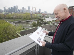 John Gutpell, at the Corticelli Lofts, studies plans for the new office building. Some residents, he says, "are going to have office workers looking directly into their apartments.”