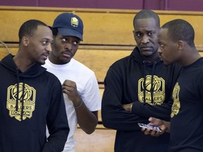 Dwight Buckley, from left, speaks with his brothers, Dillon, Dwayne and Damian as the Buckley brothers stage their Ballers Echelon tryout combine at Concordia University in Montreal on Sunday, May 13, 2018.